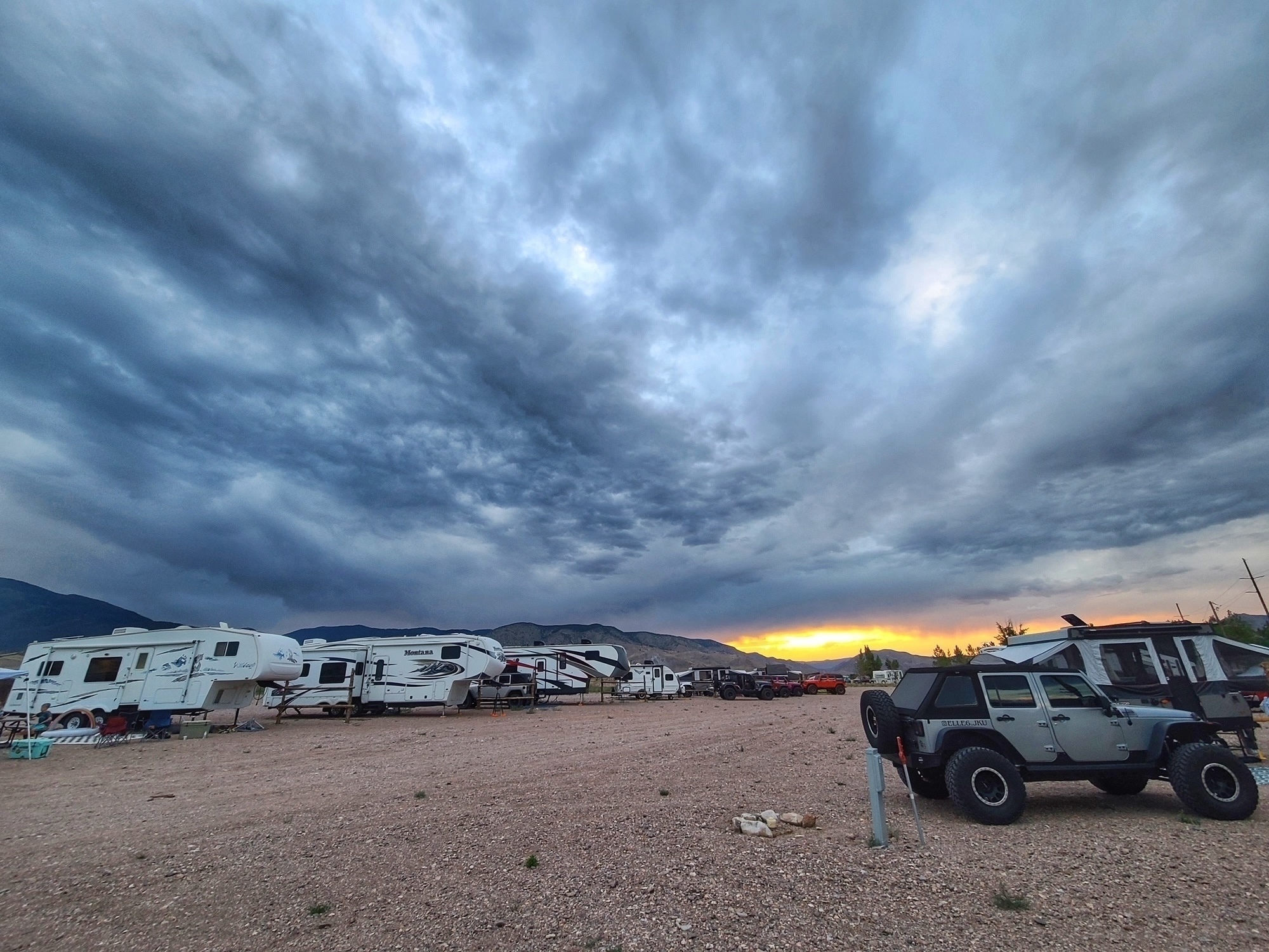 Rigs and Jeeps at Marysvale RV Park with dramatic sky