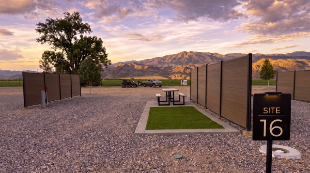 Modern RV site at Marysvale RV Park with privacy walls, turf pad, picnic table and mountain views